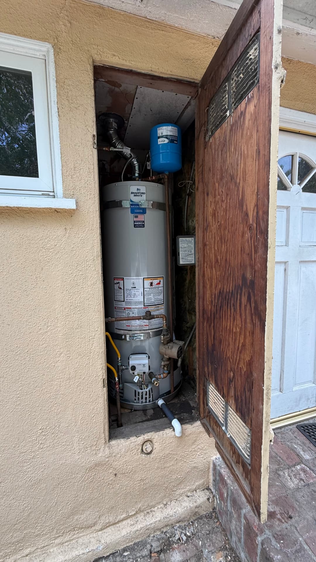 Completed traditional tank water-heater installation with new supply lines